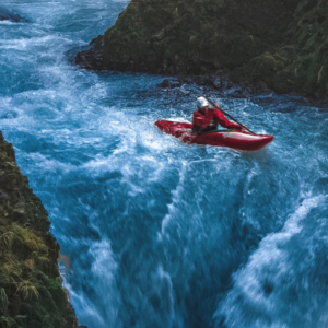 A kayaking person on a turbulent river