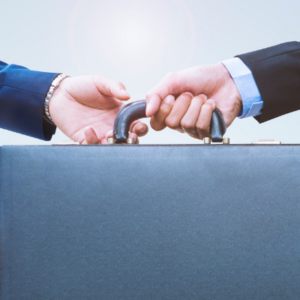 Two businessmen transferring a brief case