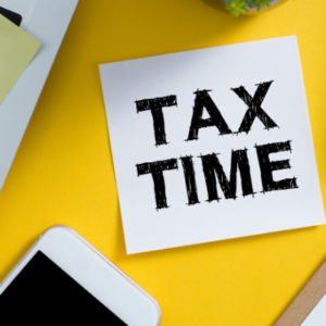 "Tax Time" written in bold letters on a sticky note